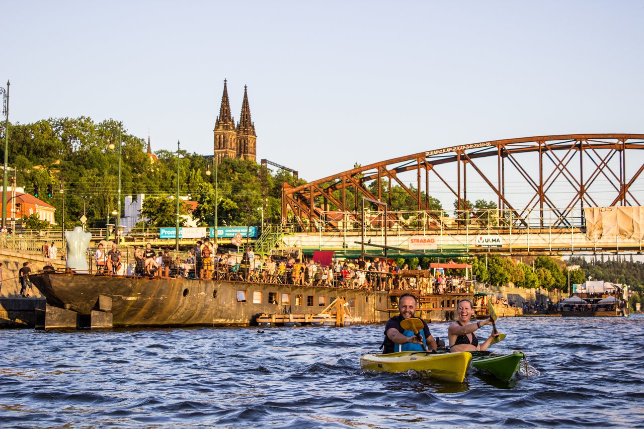 A man and a woman are kayaking