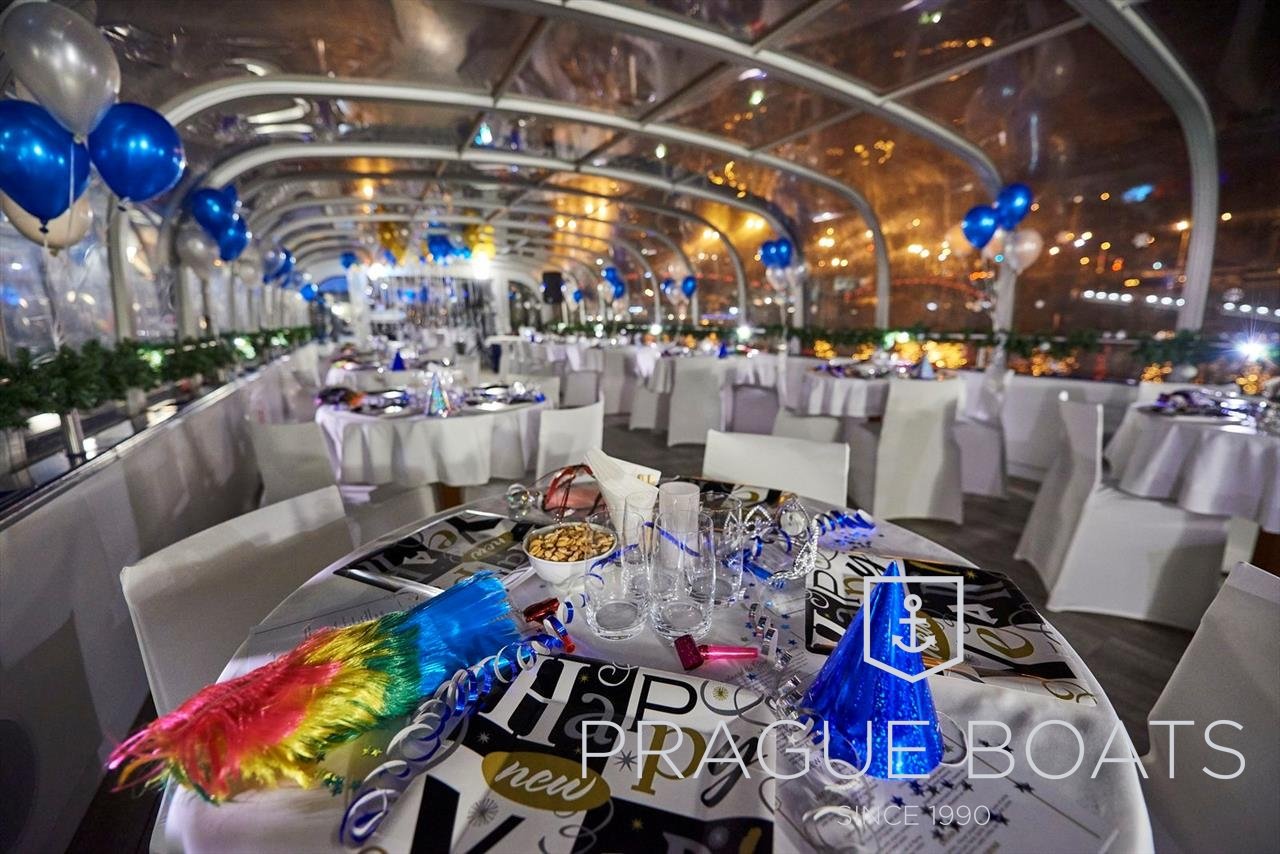 Several tables set up together with decorations on a boat